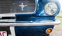 Close up view right headlight chrome grill and running horse Mustang emblem