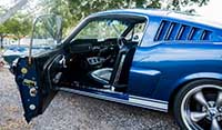 Side view Blue Shelby 1965 Mustang Fastback with view of black interior