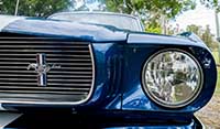 Right headlight and chrome detail Blue Shelby 1965 Mustang muscle car