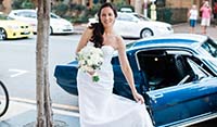 Bride being delivered to the ceremony in a Blue Shelby 1965 Mustang Fastback