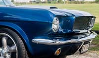 Close up view front Blue Shelby 1965 Mustang Fastback American torque thrust racing wheels