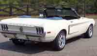 Rear view of White convertible 1966 Mustang with the top down
